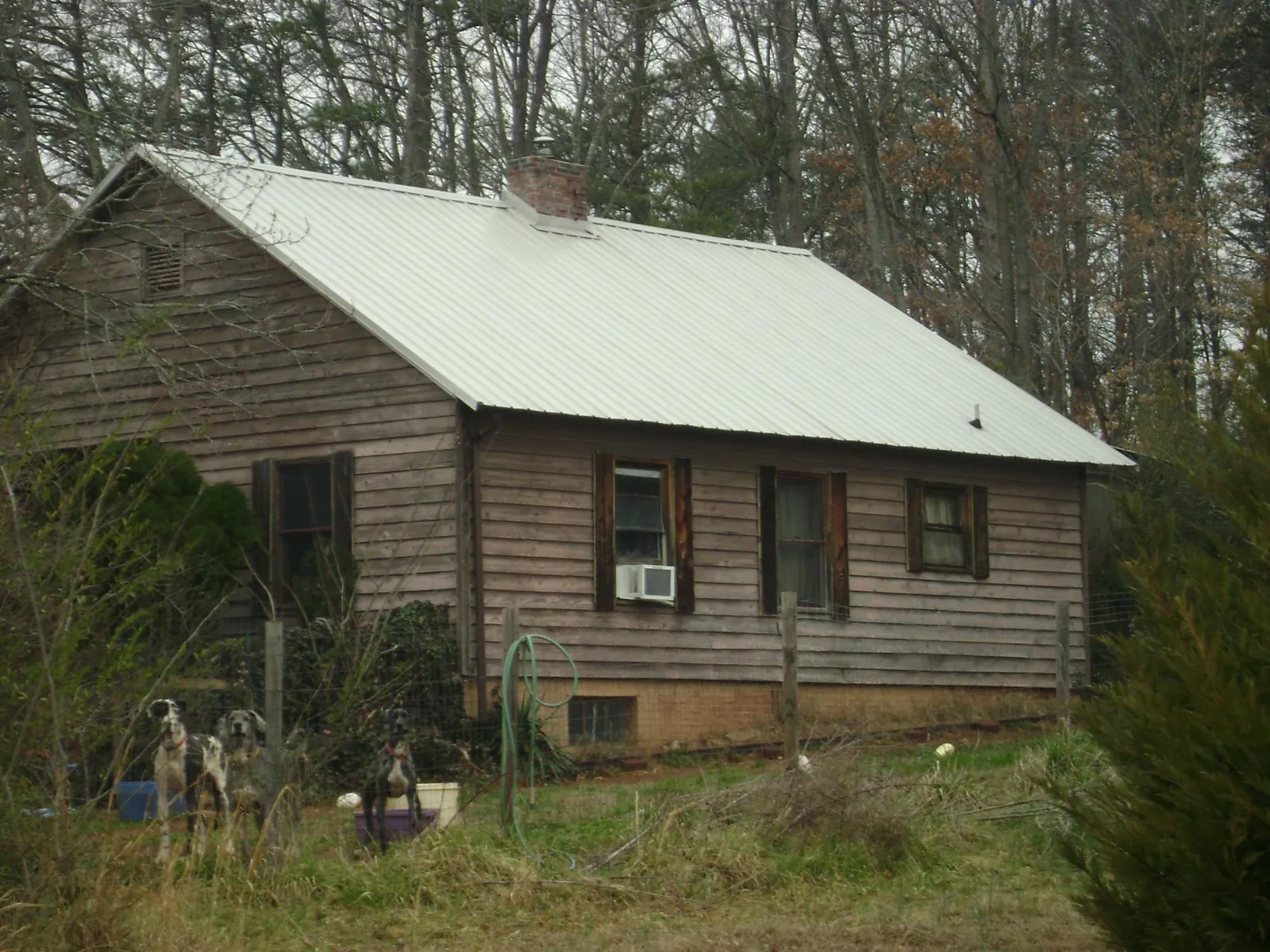 White metal roof on an old wood sided farmhouse, from a Metal Roof Installation job in Hardyville